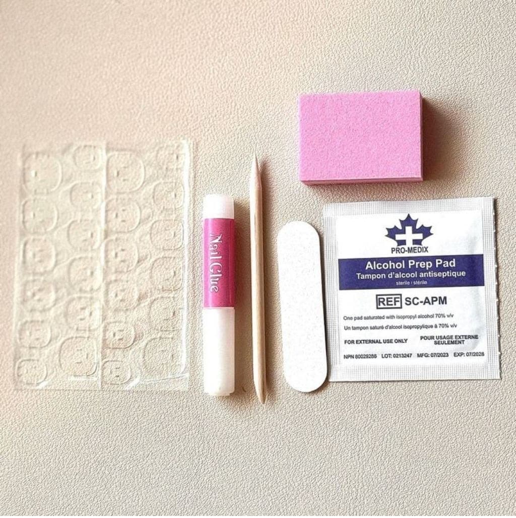 The Nailbar application kit: adhesive tabs, nail glue, cuticle stick, file, buffer and an alcohol prep pad